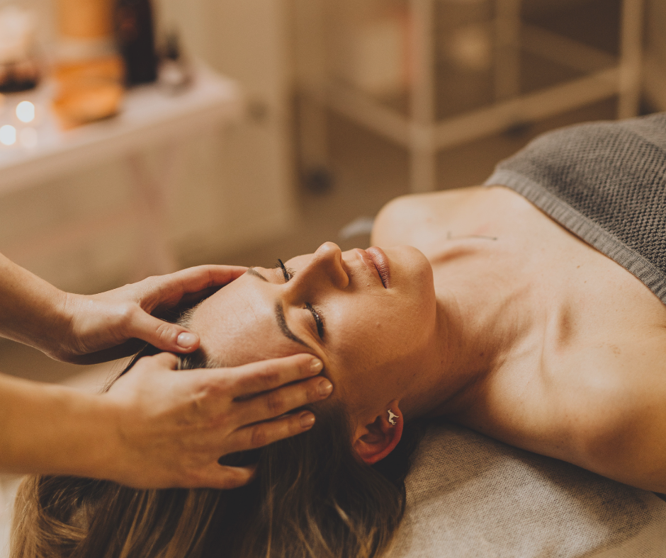 Person receiving head massage and energy balancing in spa setting at Massage Wellness & Beyond Lansdale